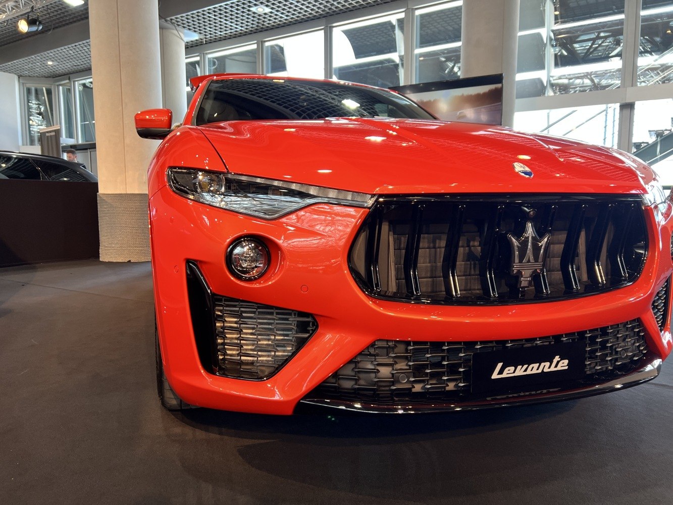 Close-up view of a car front with sleek headlights and prominent grille