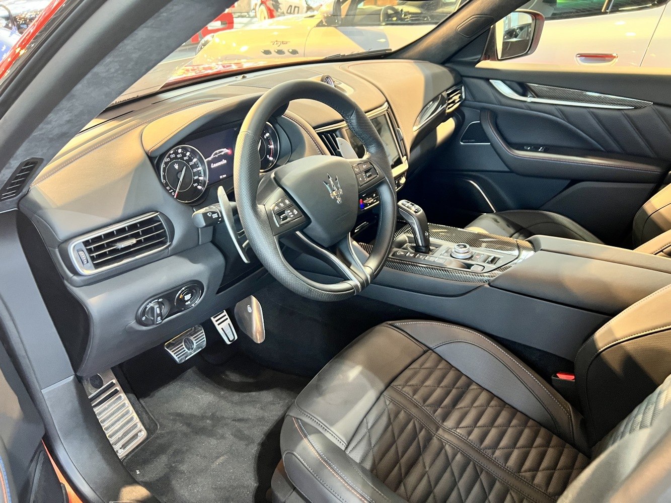 Luxurious dashboard, steering wheel, and quilted leather seats in a premium SUV interior