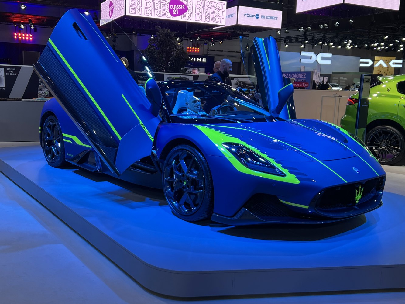 Blue sports coupe with vertical doors and neon green accent lines