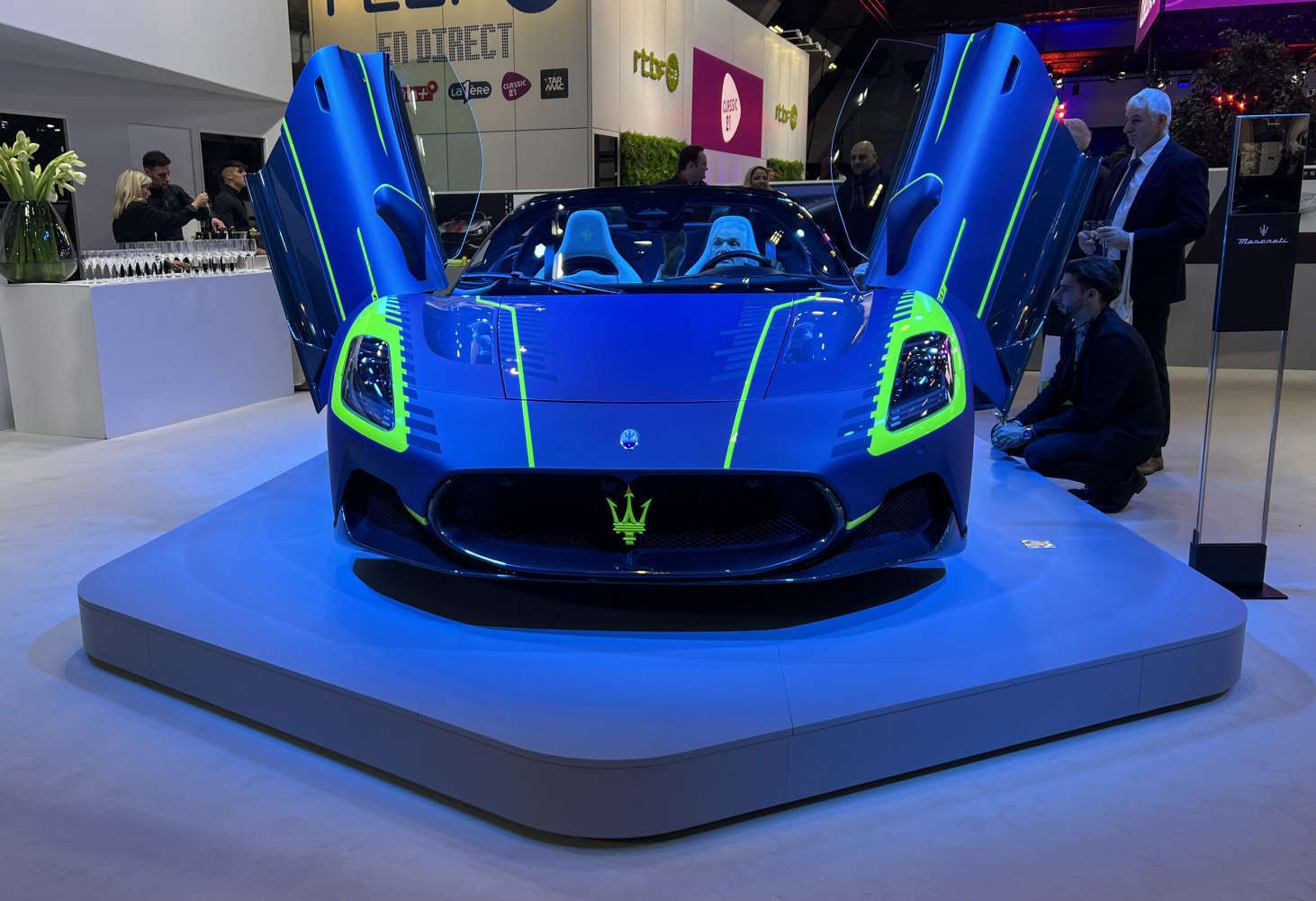 Blue sports car front with butterfly doors and neon green accents