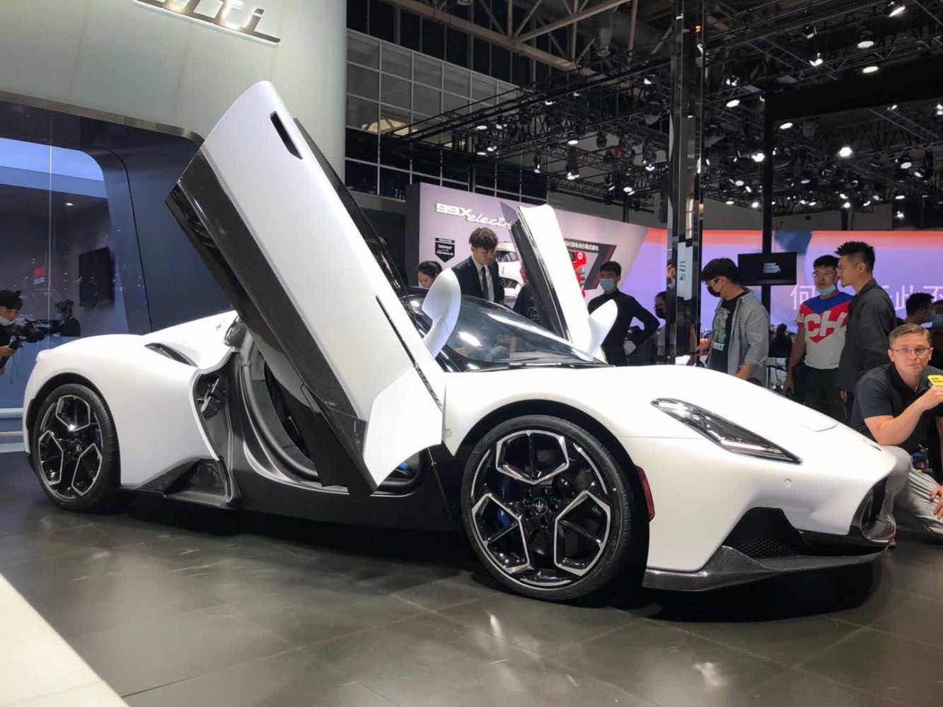 Supercar with butterfly doors and hexagonal alloy wheels