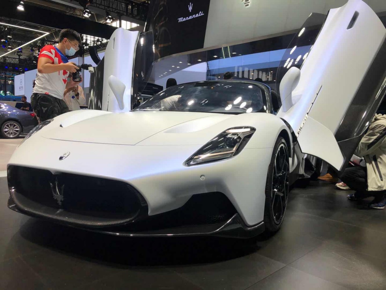 Scissor doors and aerodynamic front bumper design
