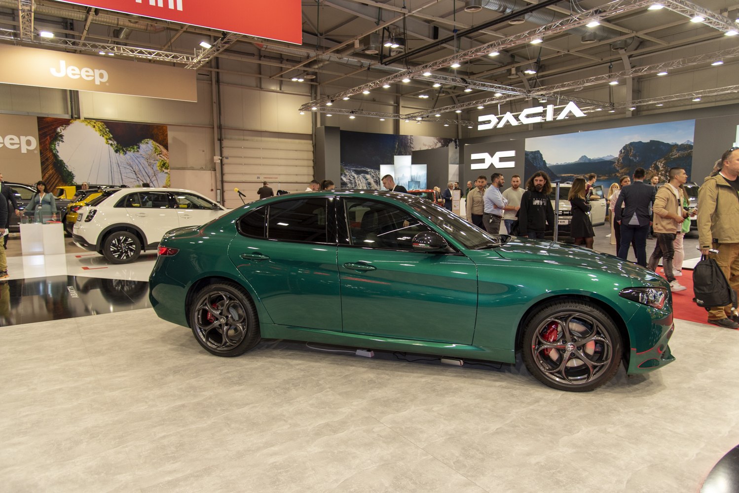 Green sedan with black alloy wheels and tinted windows