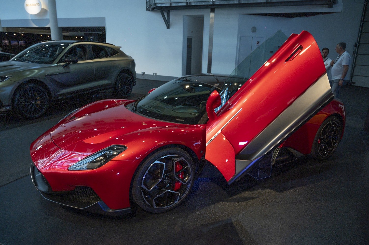 Red sports car with butterfly doors and sleek aerodynamic design