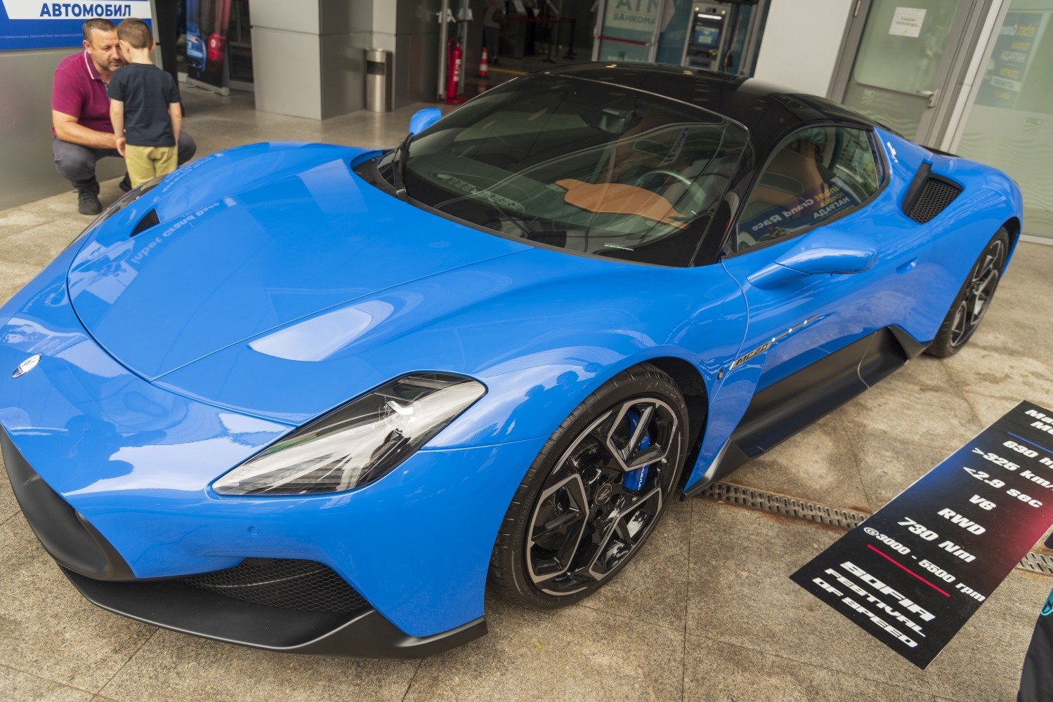 Sleek front and side view of a blue high-performance sports coupe