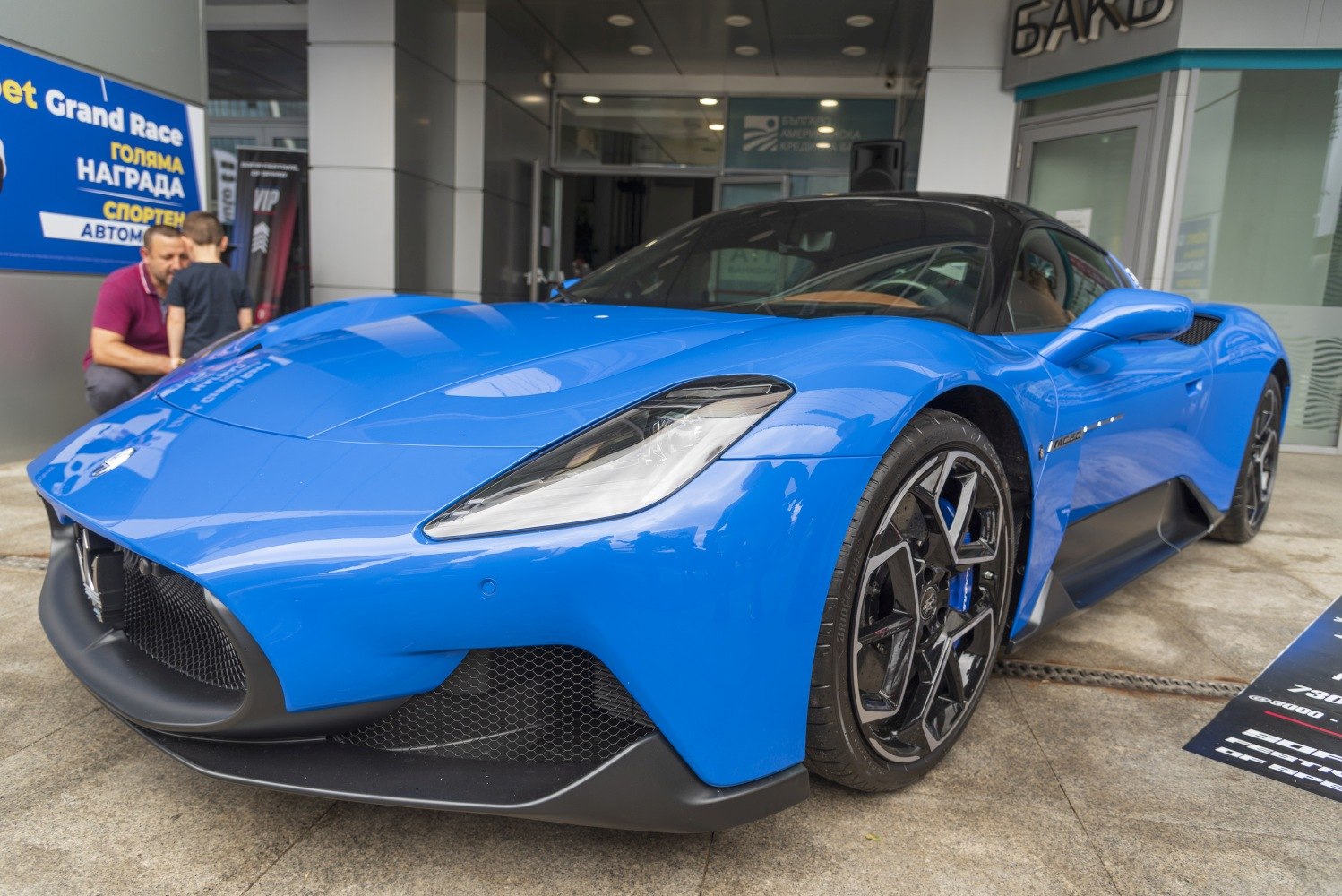 Aerodynamic front end with sleek headlights and black alloy wheels in blue finish