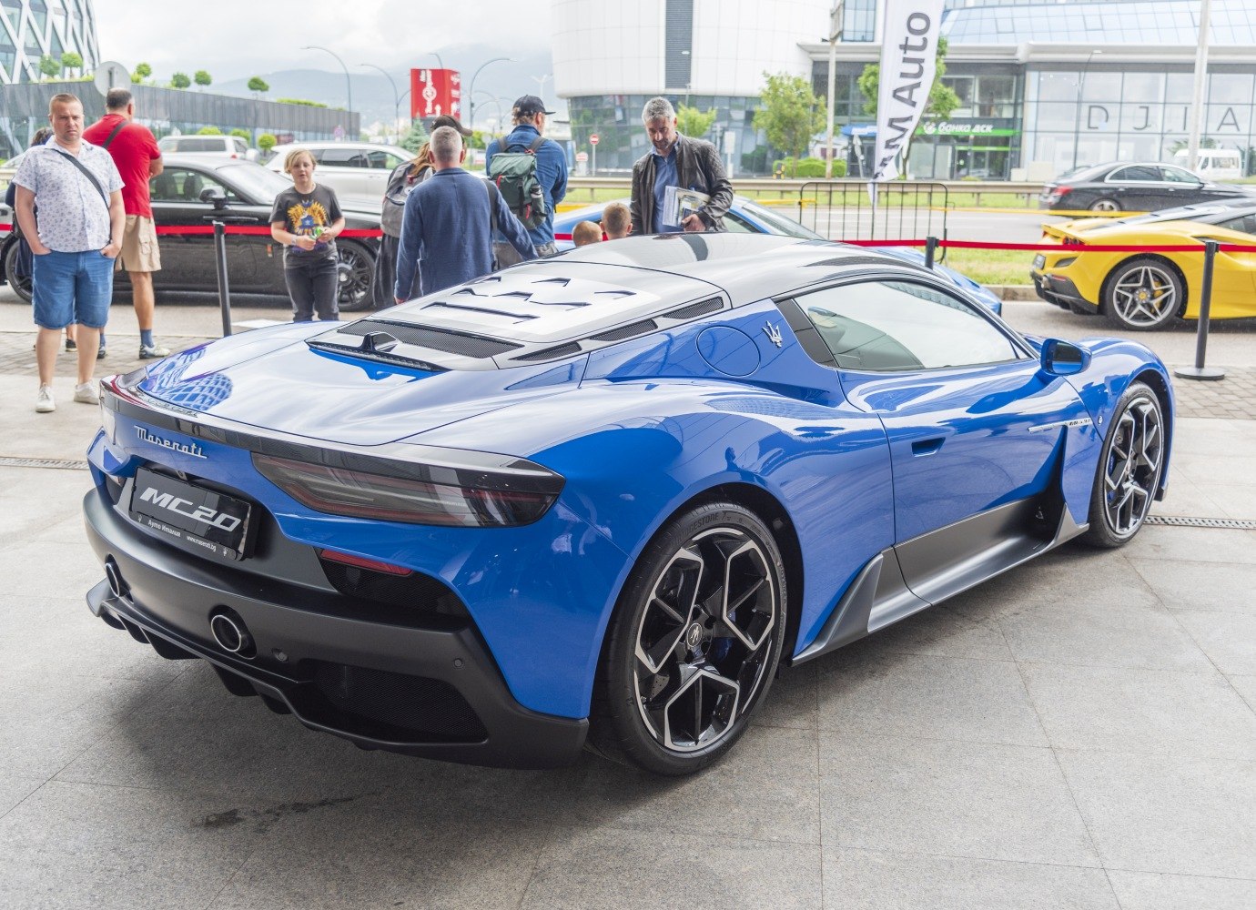Rear and side view of a sleek modern coupe with aerodynamic styling and unique wheels