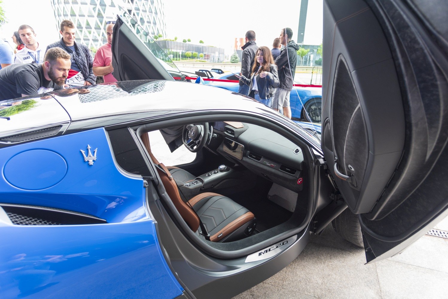 Luxury car interior with butterfly doors open.