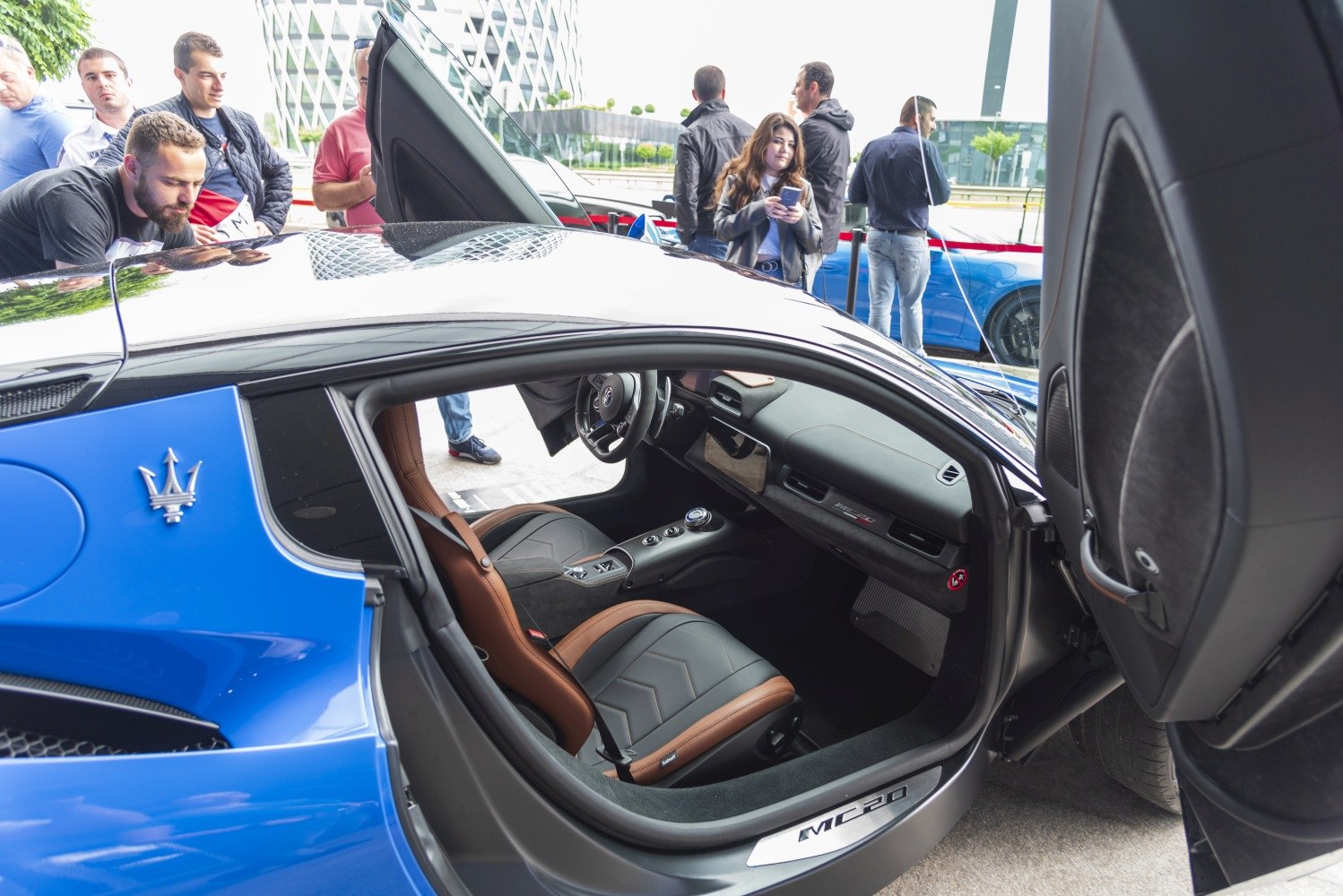 Interior view of a luxury sports car with butterfly doors open