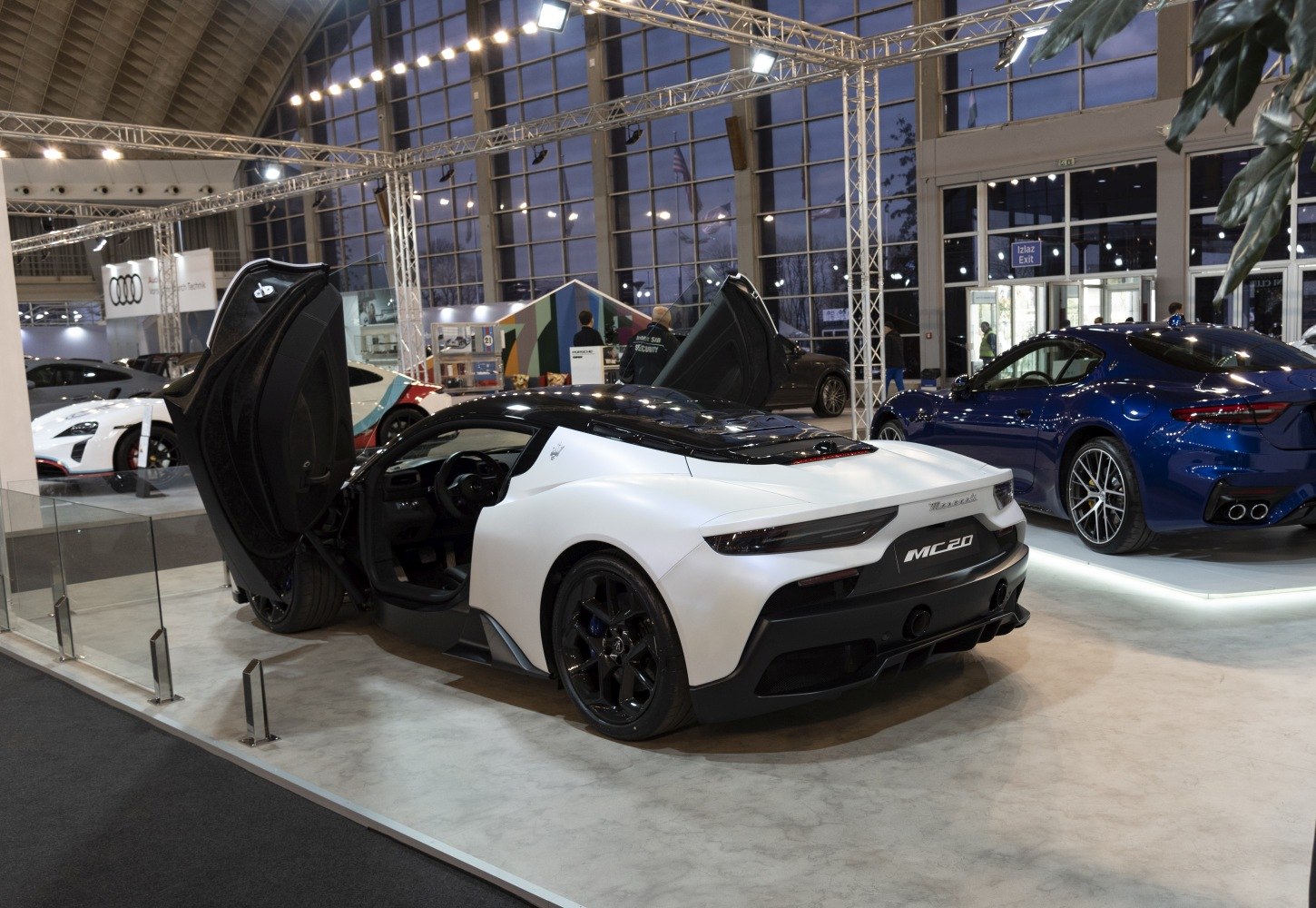 Rear view of a supercar with open butterfly doors and sleek modern design