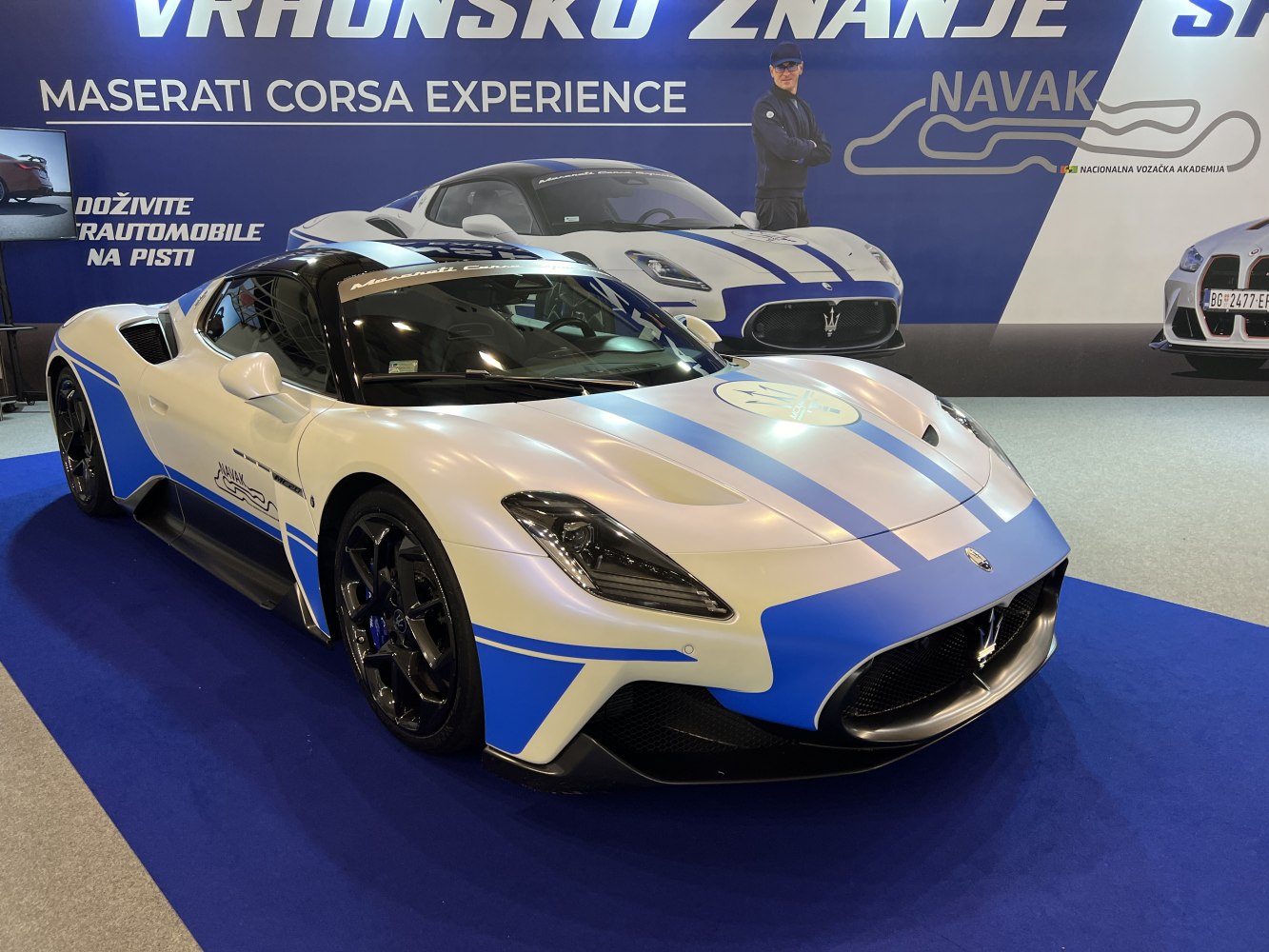Front and side view of Maserati MC20 with blue racing stripes and aerodynamic features