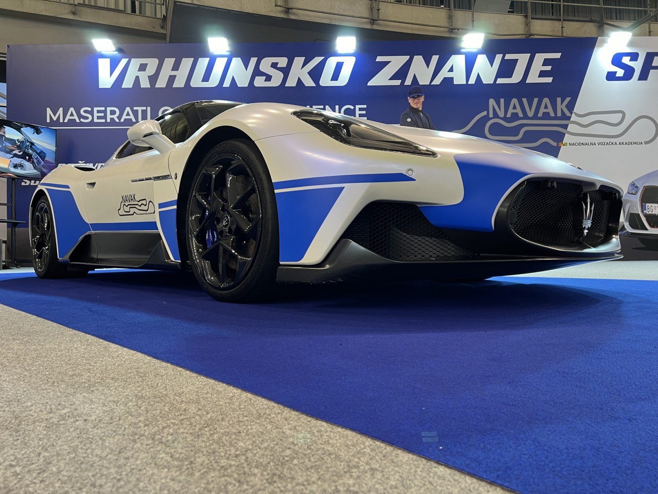 Low angle front view with aerodynamic design and black alloy wheels