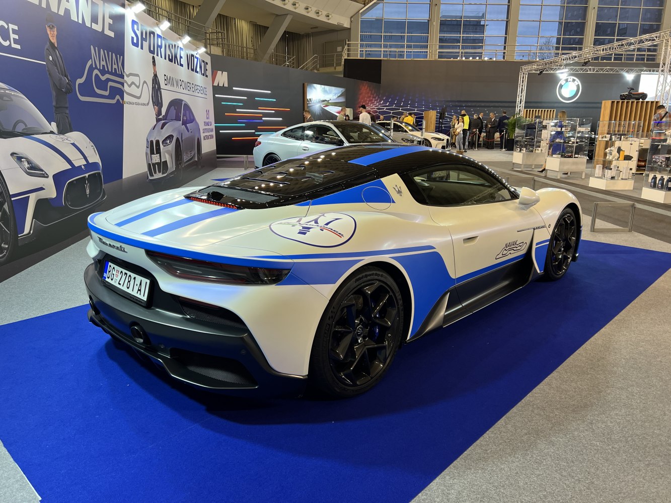 White and blue sports coupe with racing stripes and black roof