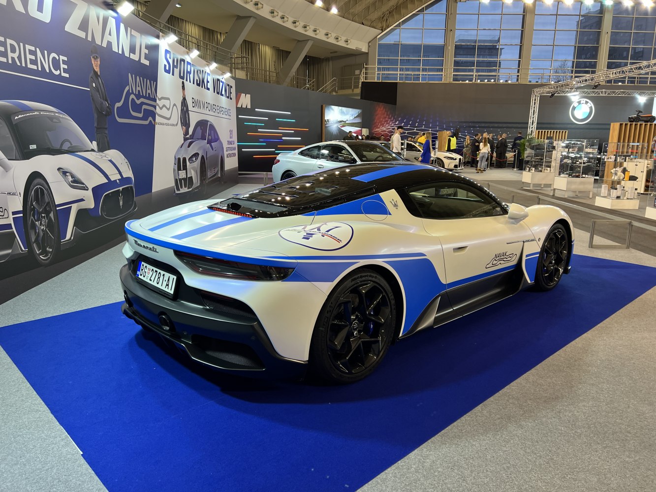 Rear side view of a sports car with racing stripes and decals