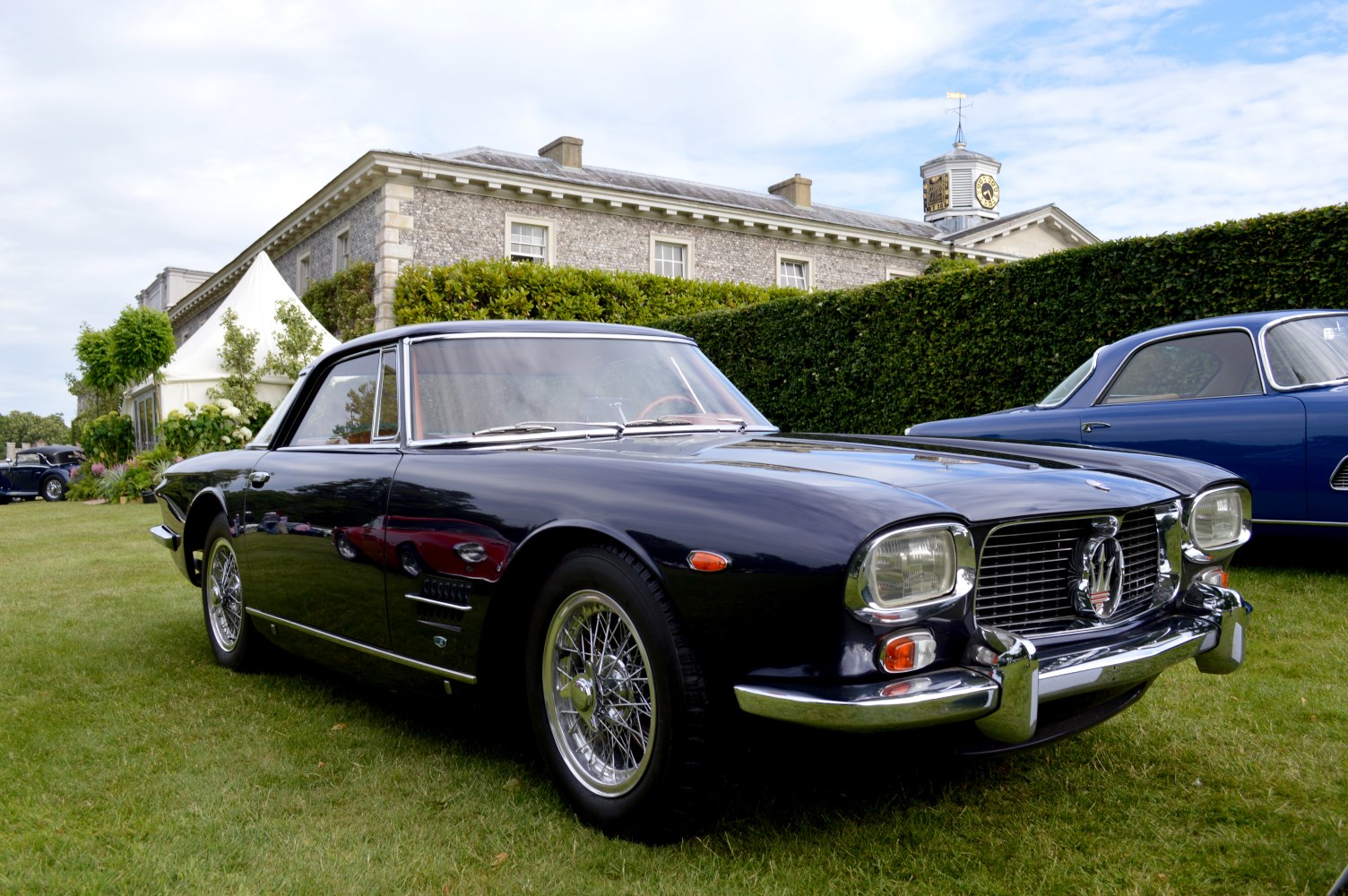 Vintage coupe with wire spoke wheels and prominent front grille