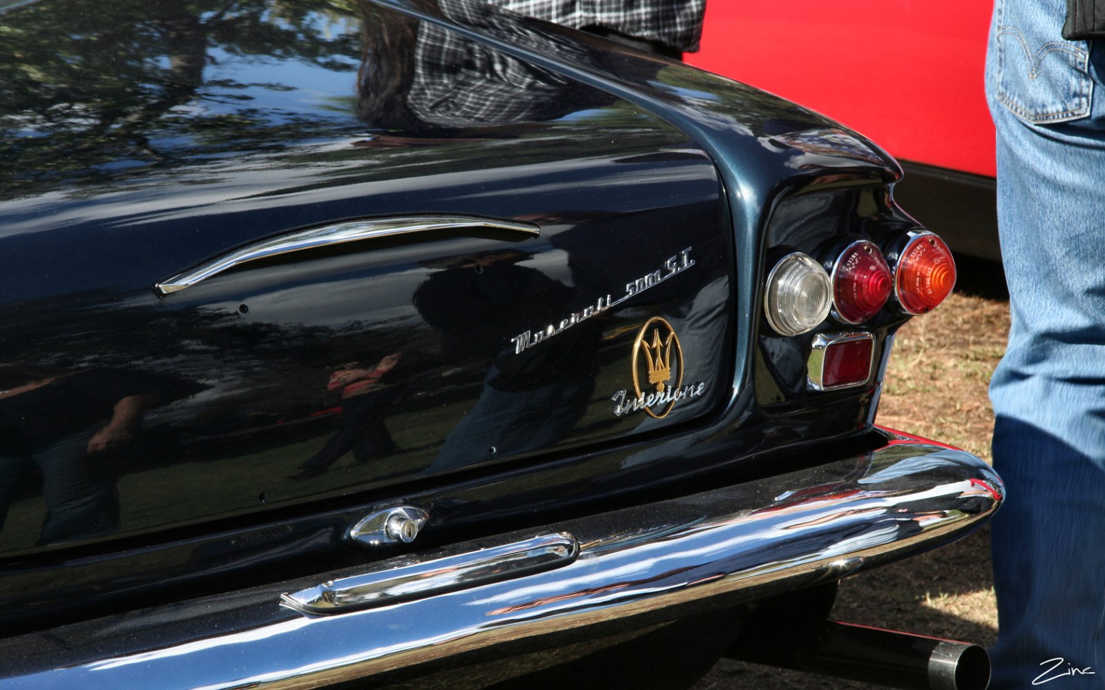Rear tail lights, chrome bumper, emblem and badge on classic car