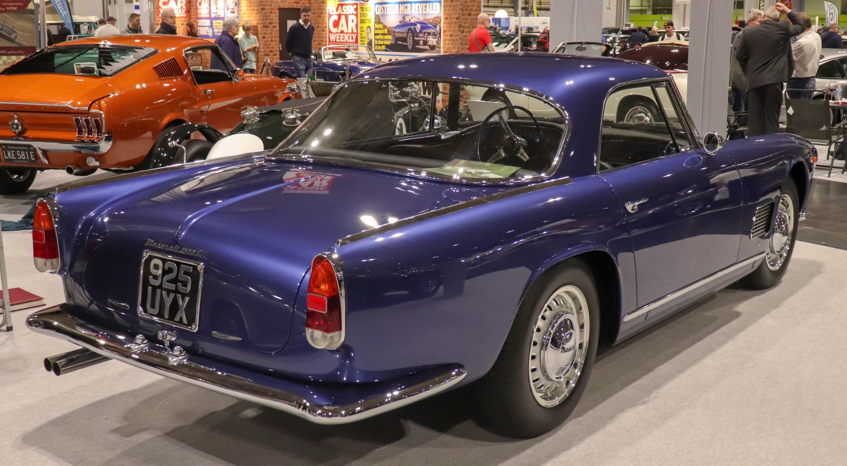 Classic blue coupe rear view with tail lights and chrome bumper