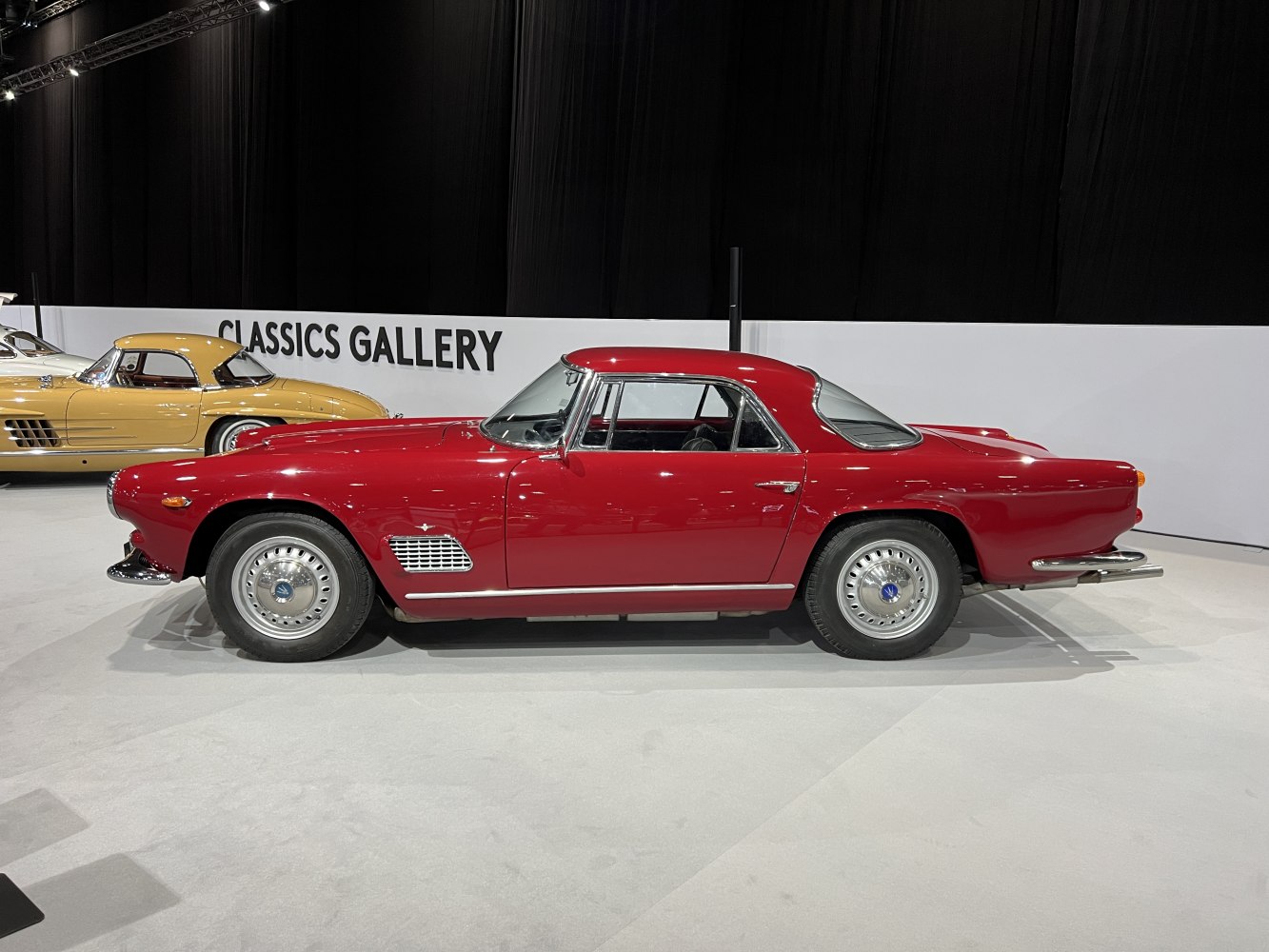 Vintage coupe side profile with smooth lines and chrome accents