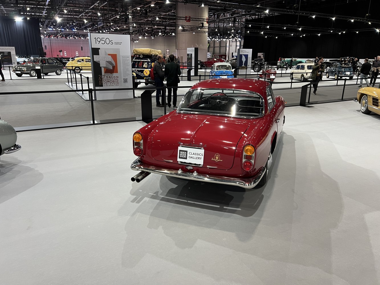 Red vintage coupe rear view with distinctive taillights and chrome bumper