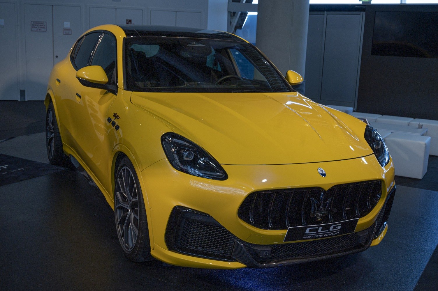 Yellow luxury SUV front with aggressive grille and LED headlights
