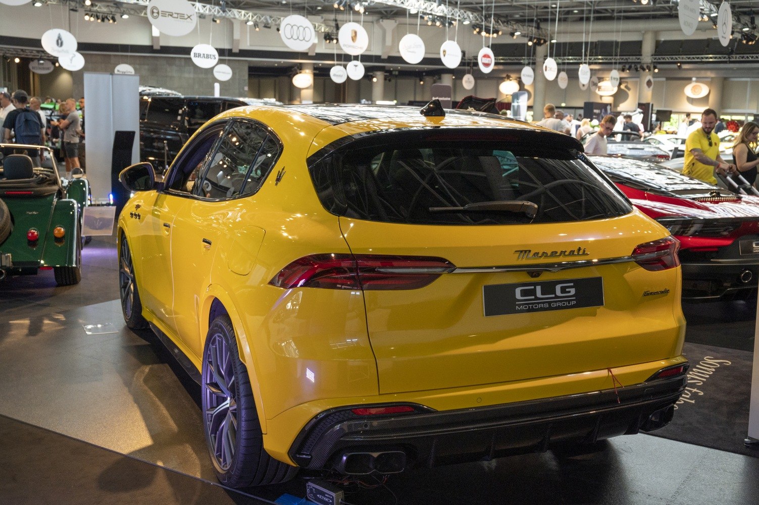Rear view of a sporty yellow SUV with sleek taillights and black roof