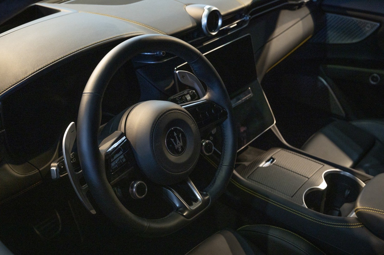 Steering wheel and center console with digital display and detailed stitching