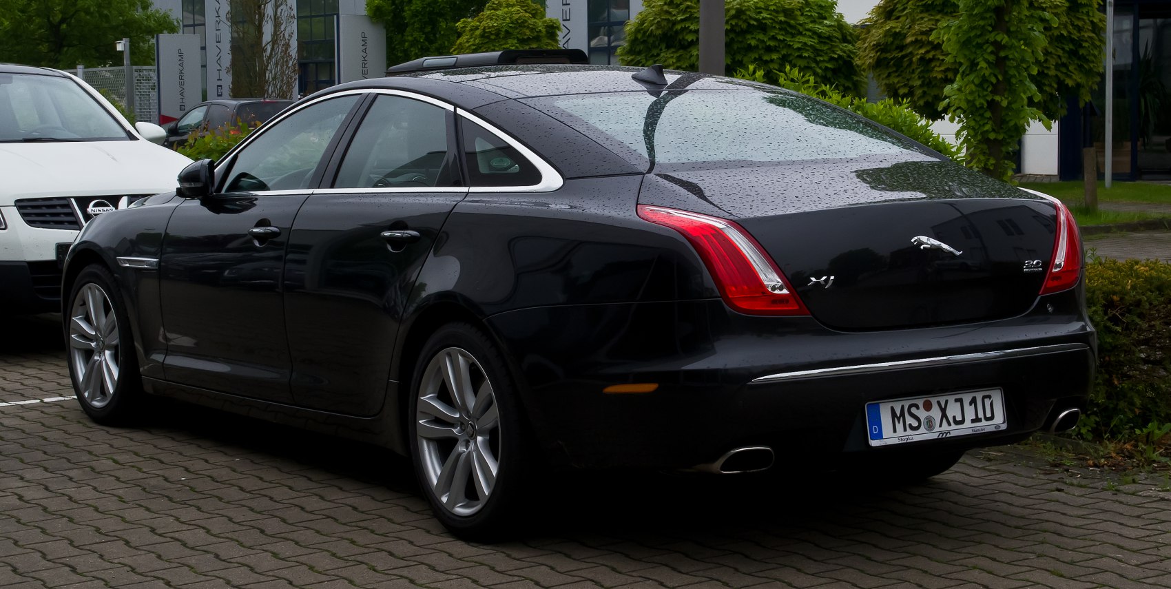 Rear side view of luxury sedan with sleek design and distinctive rear lights
