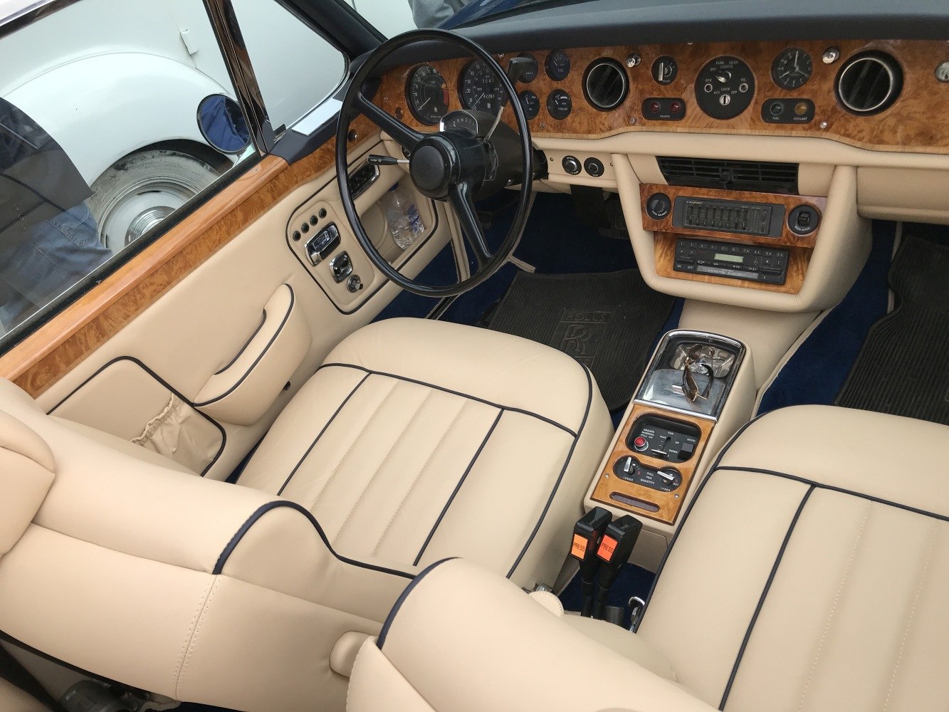 Classic wood dashboard and cream leather seats in vintage car interior