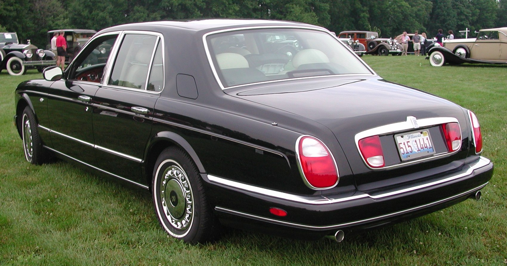 Luxury black sedan rear with oval lights and chrome trim