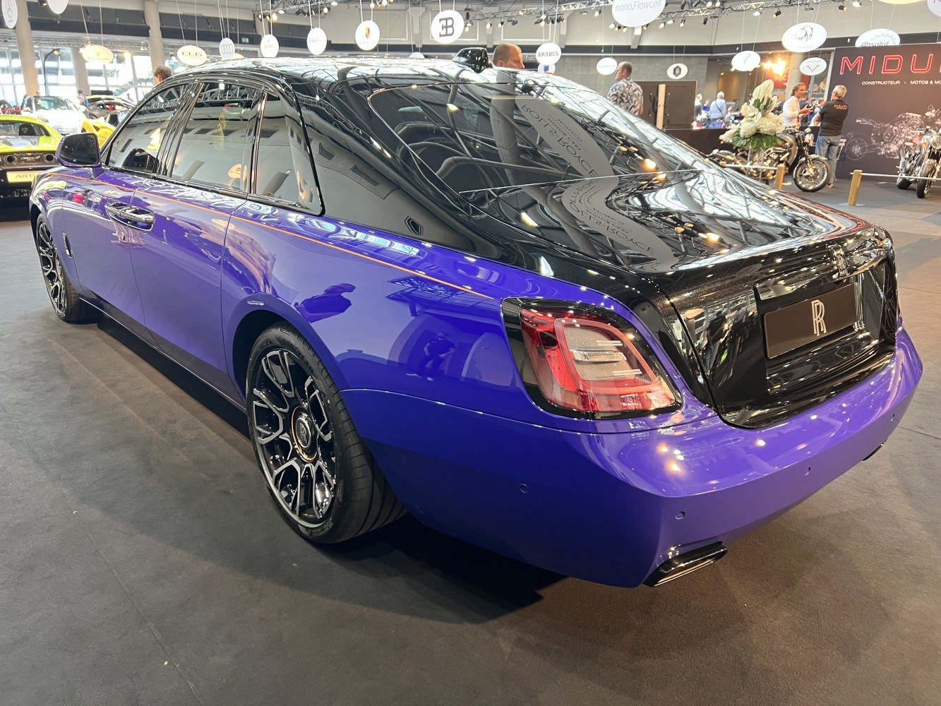 Rear view of luxury sedan with two-tone paint and distinctive taillights