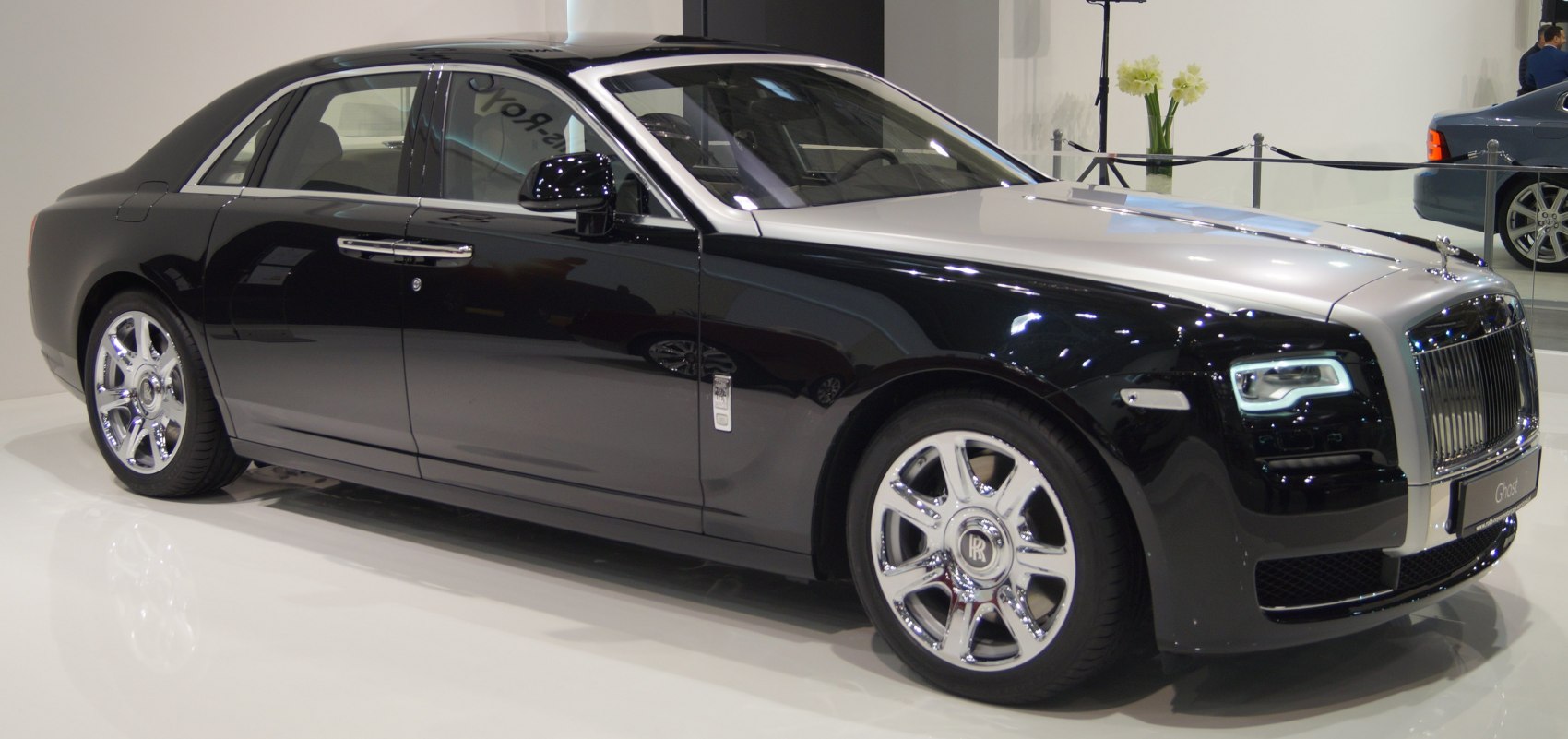 Two-tone luxury sedan with signature grille and polished wheels