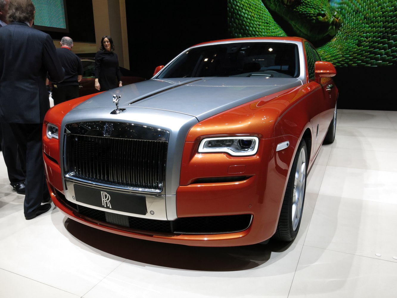 Front grille and LED headlights of a luxury sedan in silver and orange