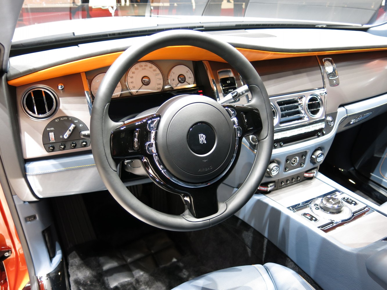 Luxury dashboard and steering wheel with instrument cluster and detailed control panels.