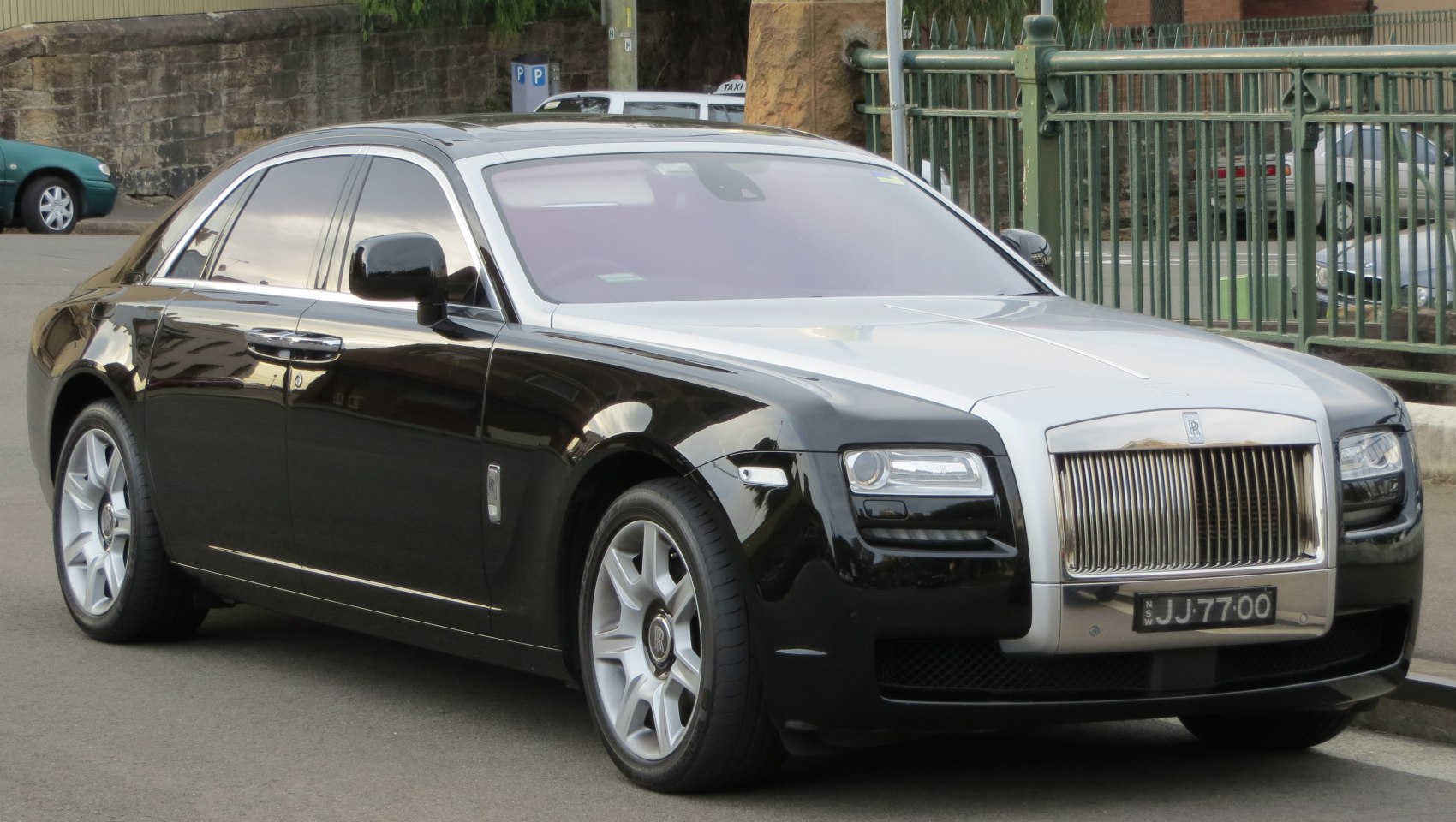 Luxury sedan with vertical grille and two-tone silver-black finish
