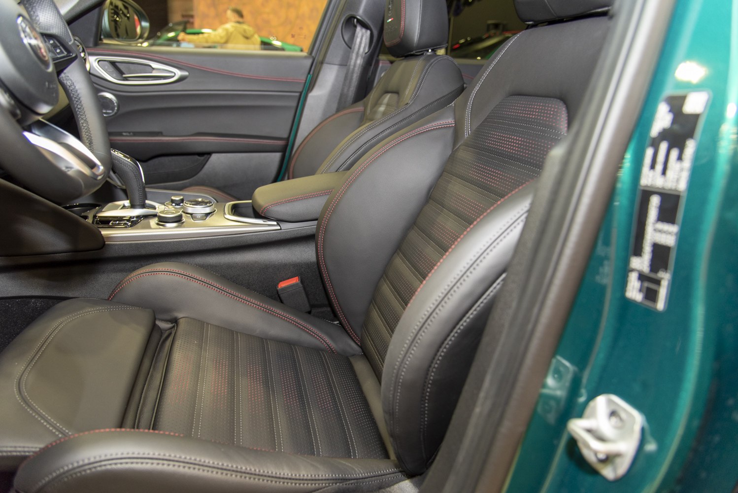 Leather sport seats and central console close-up with red stitching