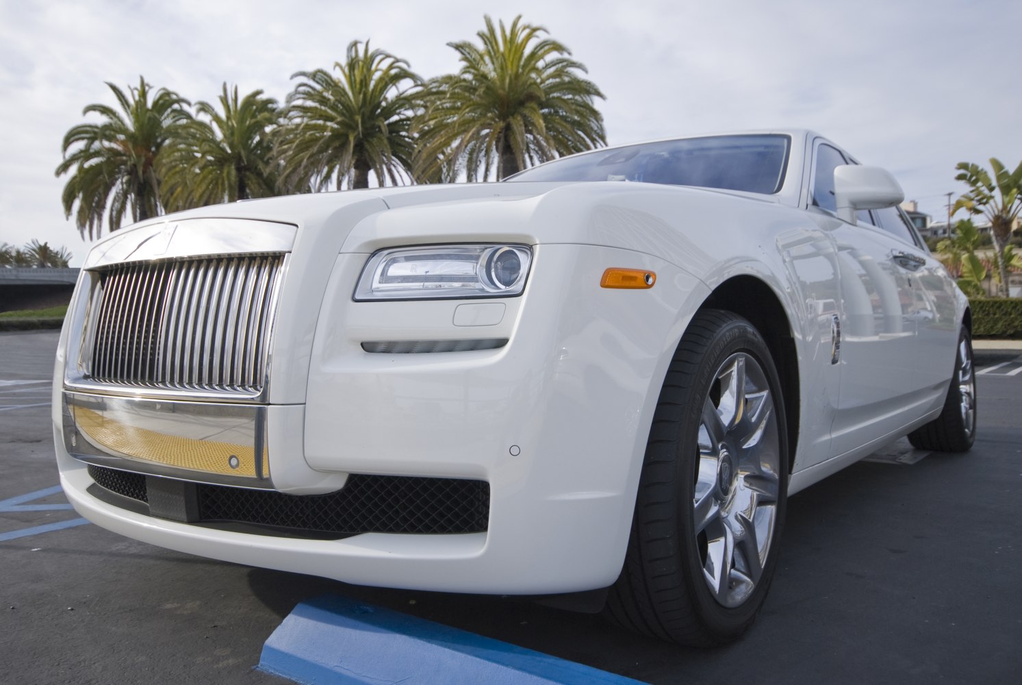 Close-up of luxury sedan front with chrome grille and modern headlights