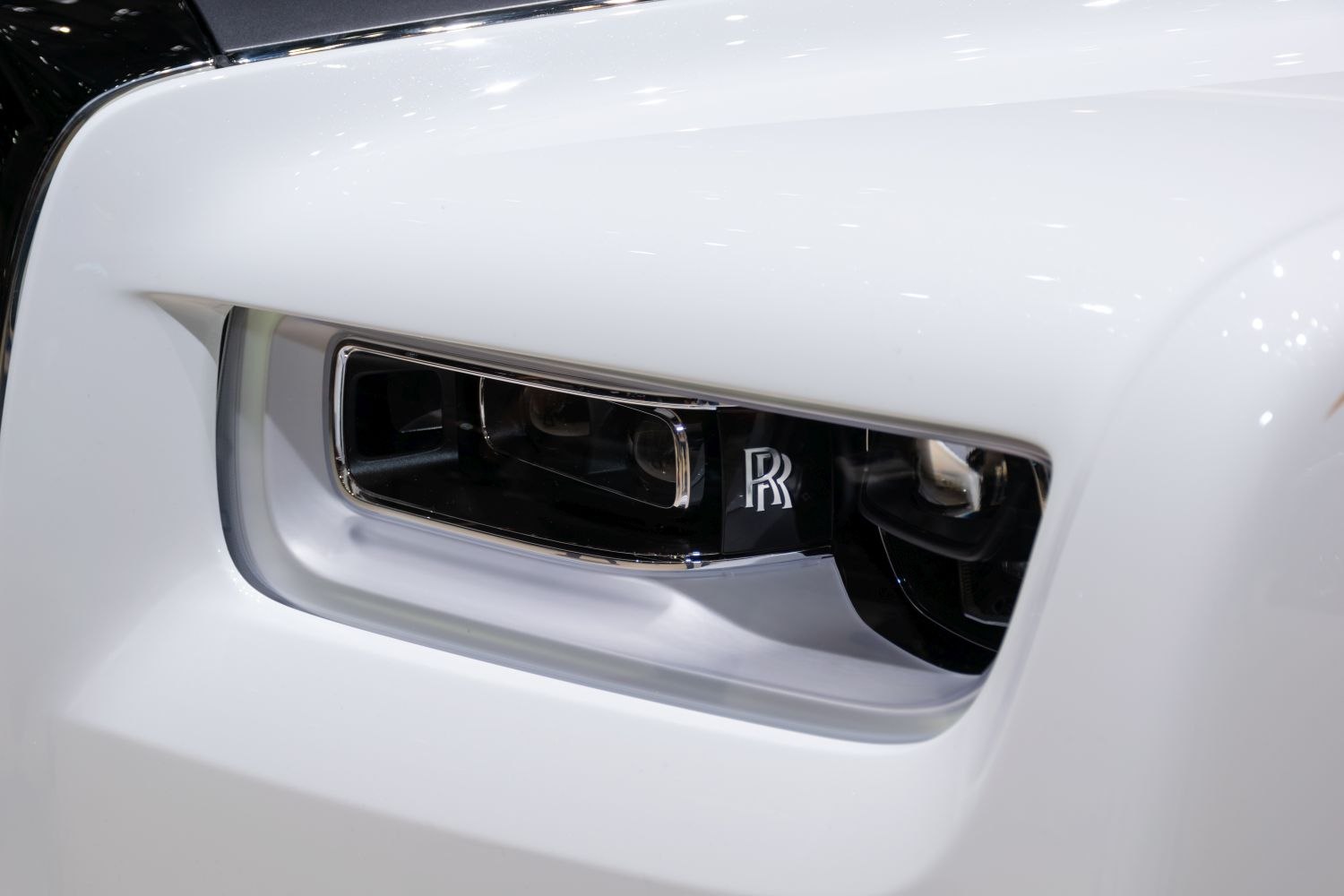 Close-up of luxury headlight with iconic logo