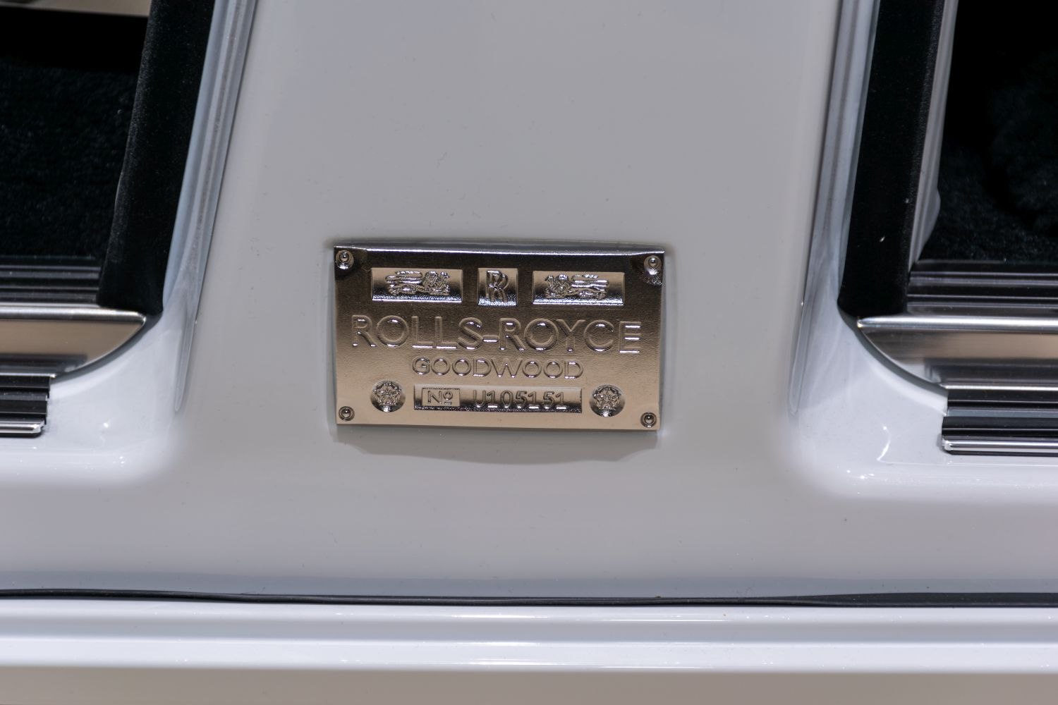 Close-up of a metallic build plaque with Rolls-Royce Goodwood branding