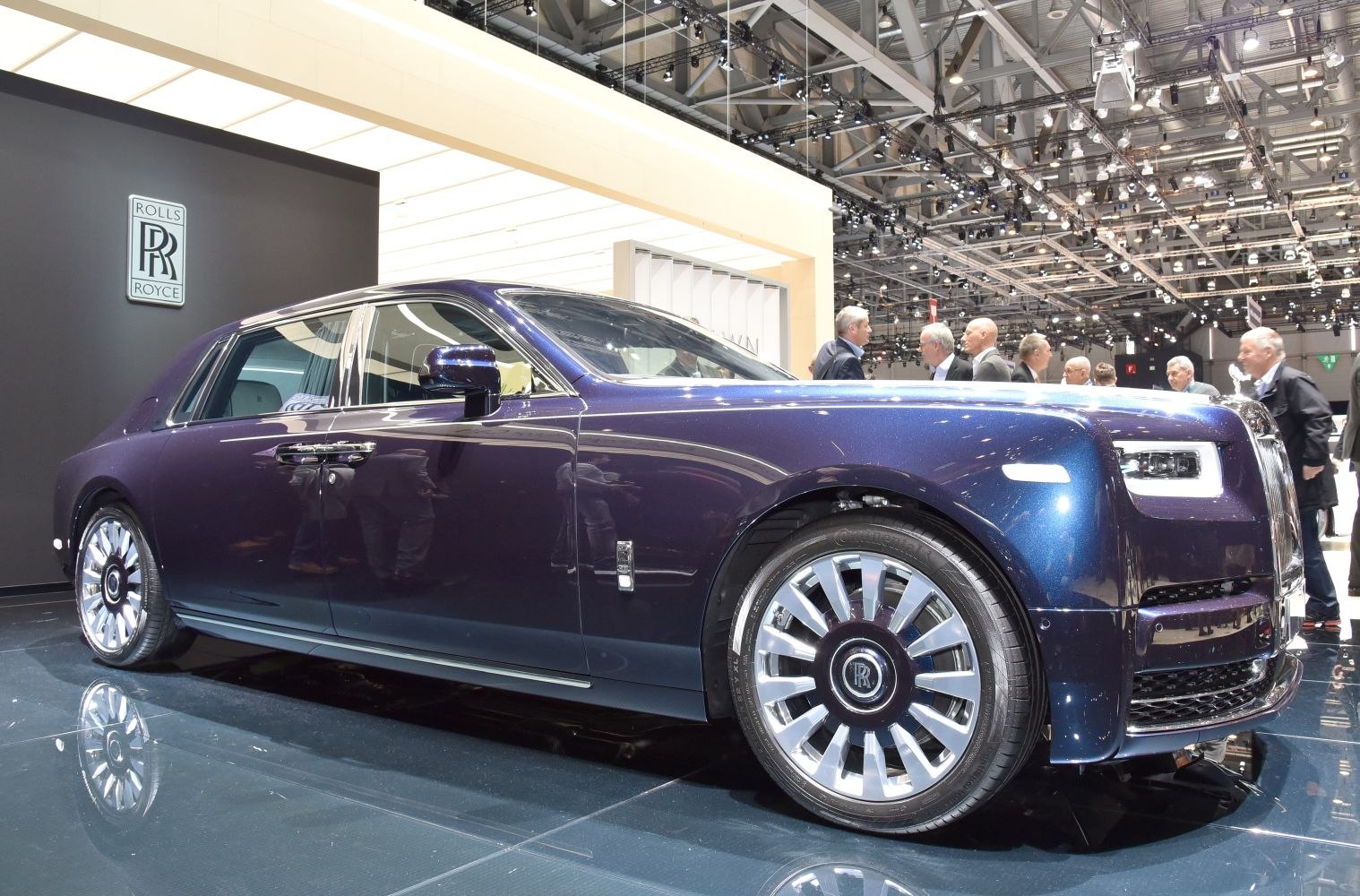 Front side view of a luxury sedan with LED headlights and chrome wheels