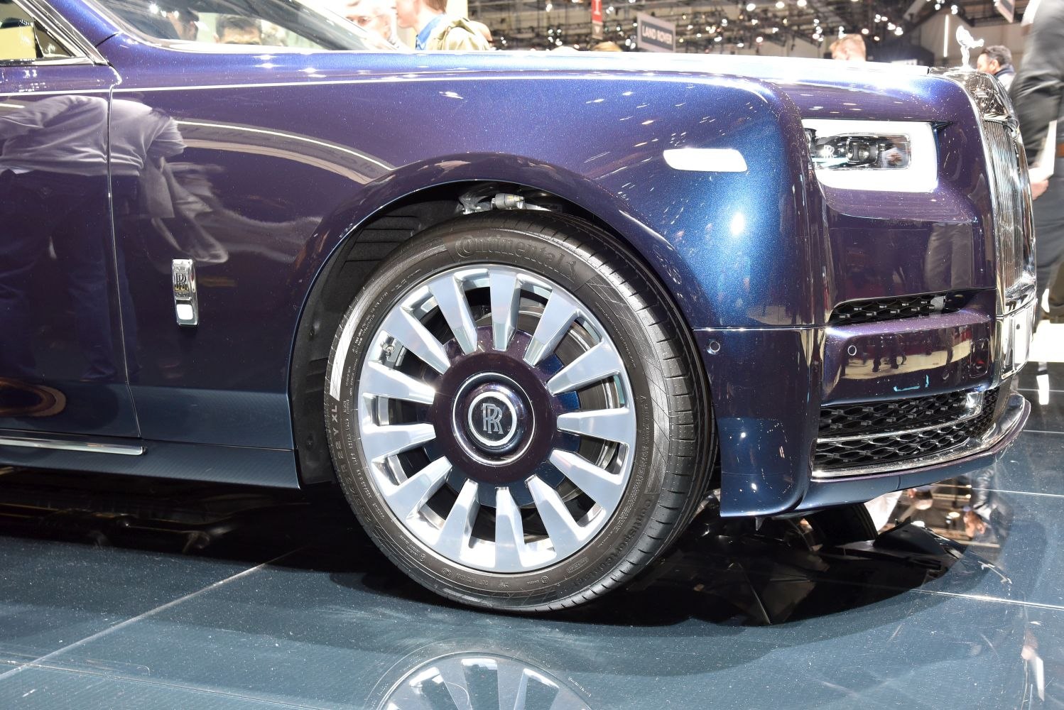 Close-up of luxury car front wheel and LED headlamp