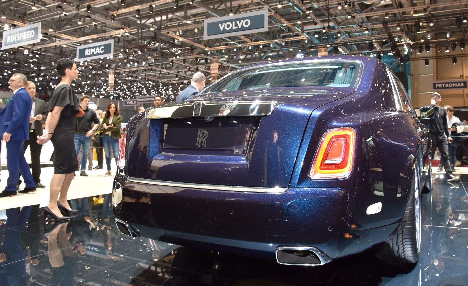 Luxury sedan rear view with distinctive taillights and dual exhausts