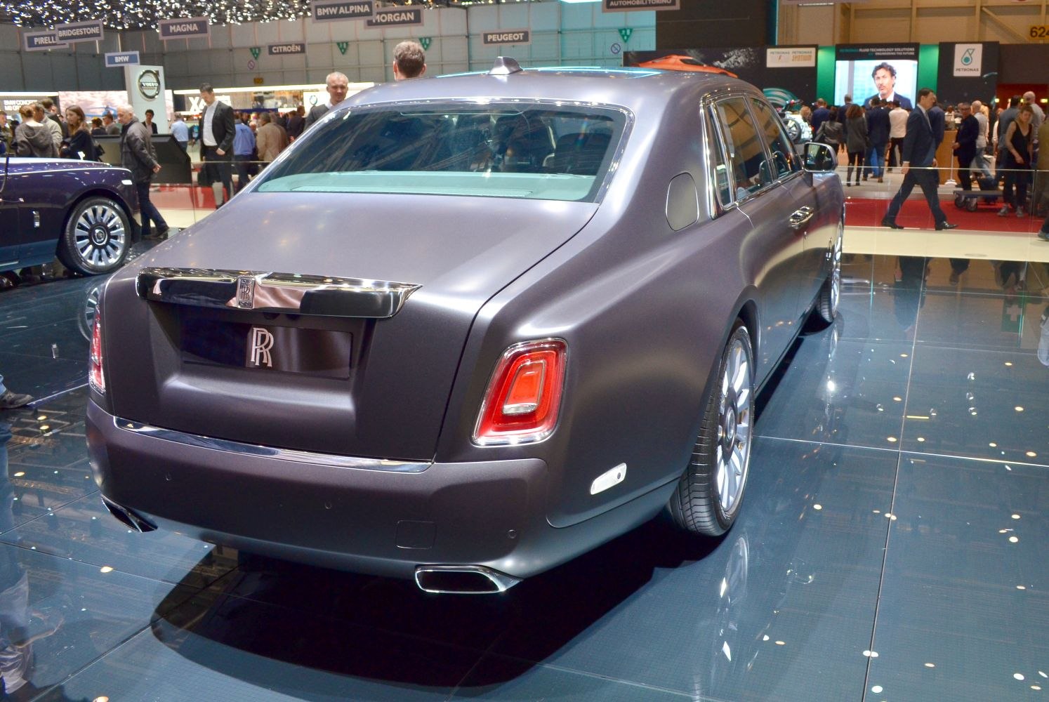Luxury sedan rear with distinctive taillights and matte finish paint