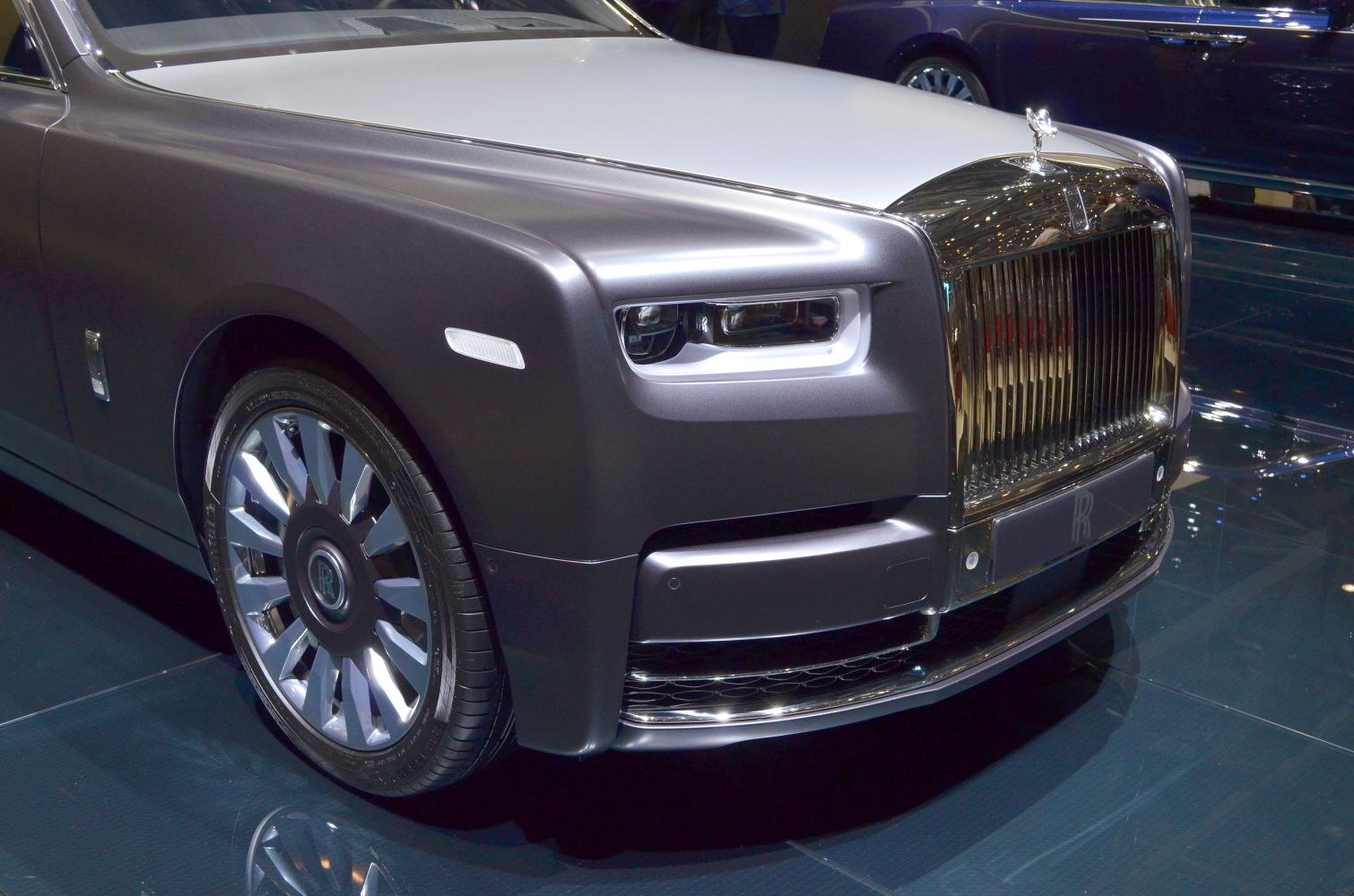 Front grille, headlight, and alloy wheel of a luxury vehicle