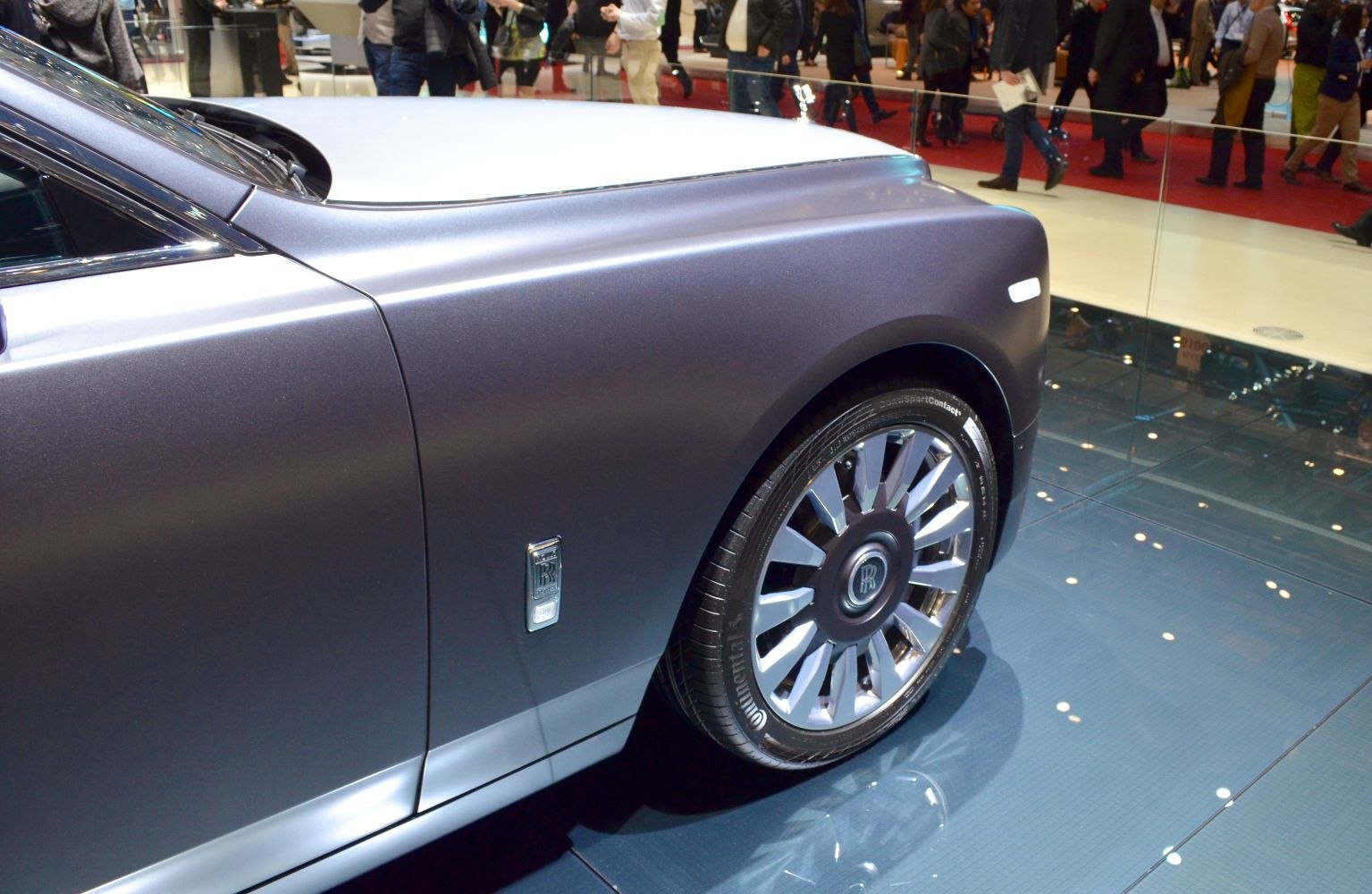 Close-up of luxury alloy wheel and smooth side panel