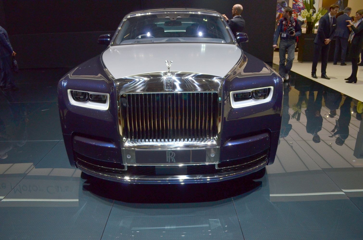 Front view of luxury car with iconic grille and LED headlights