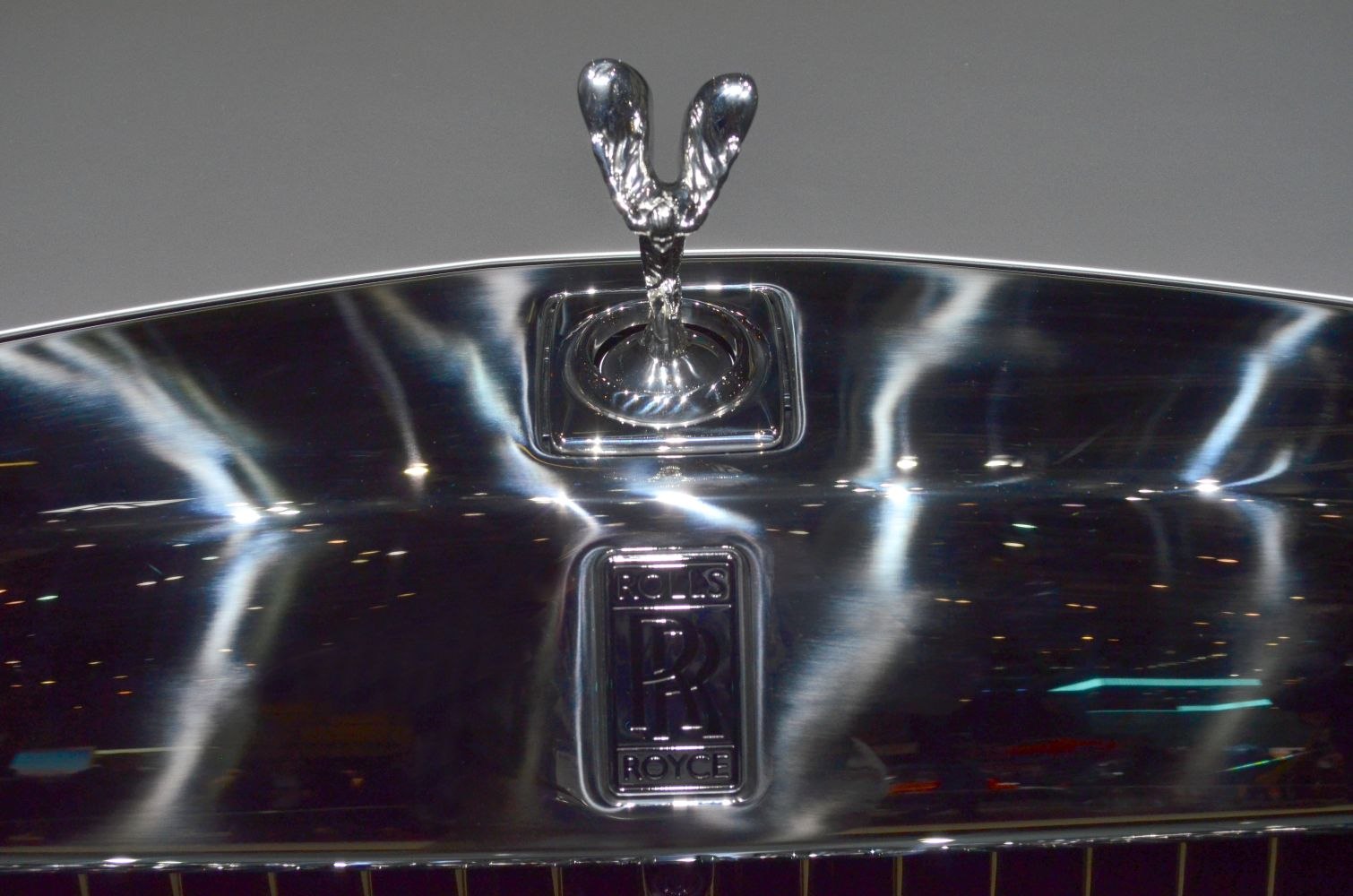 Close-up of Spirit of Ecstasy hood ornament on polished chrome surface