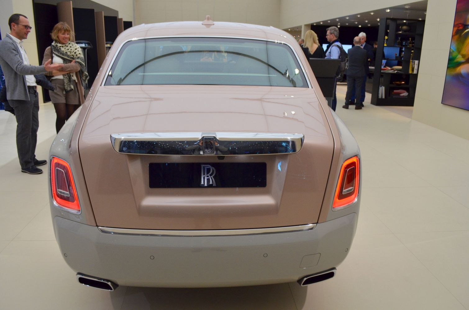 Luxury car's rear with distinctive taillights and polished chrome trim
