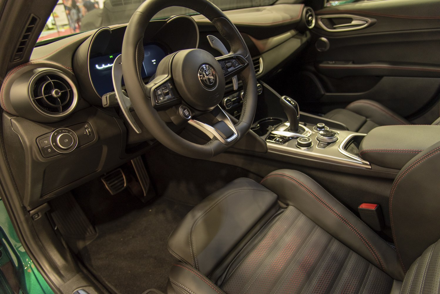 Modern steering wheel and ergonomic digital cockpit with premium materials.