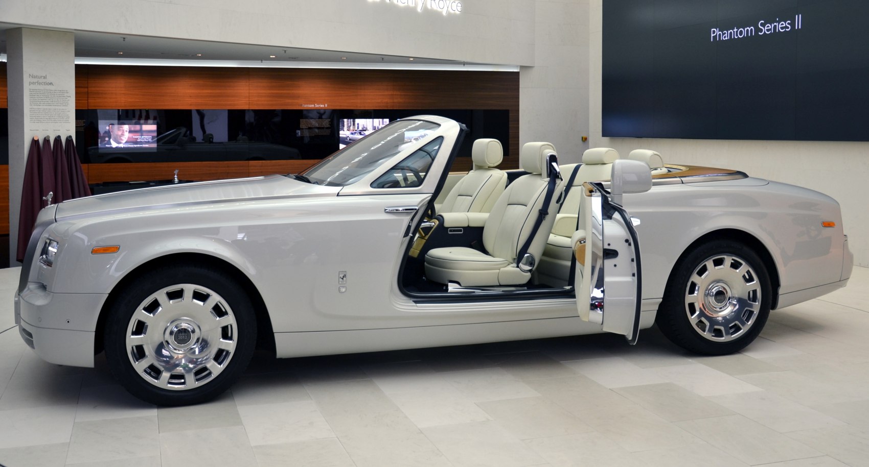 Open doors luxury convertible with premium leather seats and classic wheel design