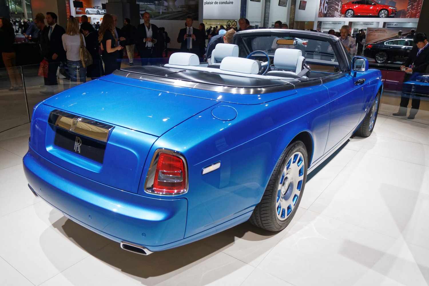 Blue luxury convertible rear with white seats and chrome trim